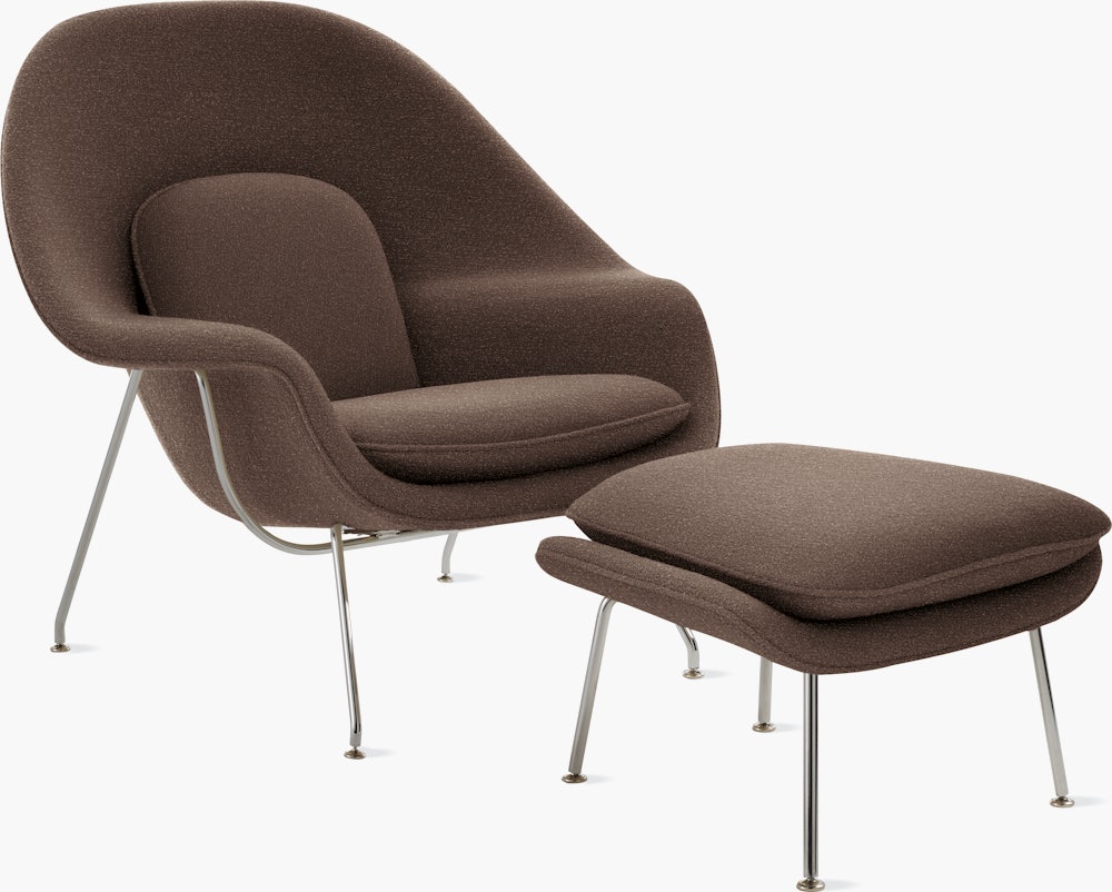 A pumpernickel Womb Chair & Ottoman viewed from an angle