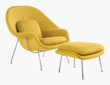 A yellow Womb Chair & Ottoman viewed from an angle