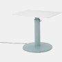 OE1 Sit-to-Stand Table with light blue base and white rectangular surface viewed from a front angle.