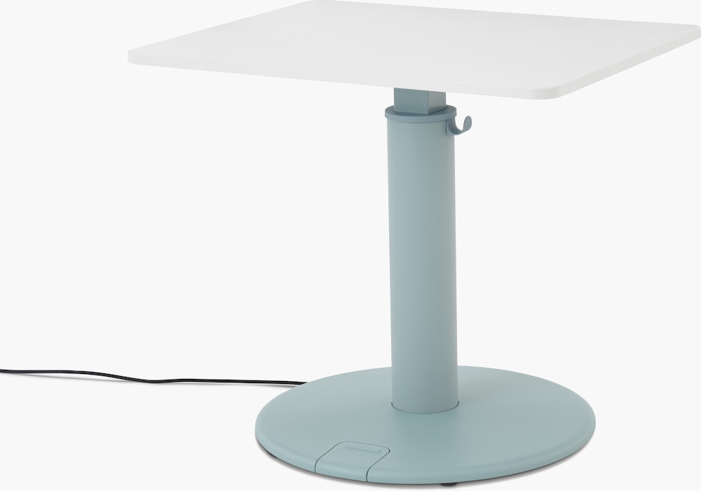 OE1 Sit-to-Stand Table with light blue base and white rectangular surface viewed from a front angle.